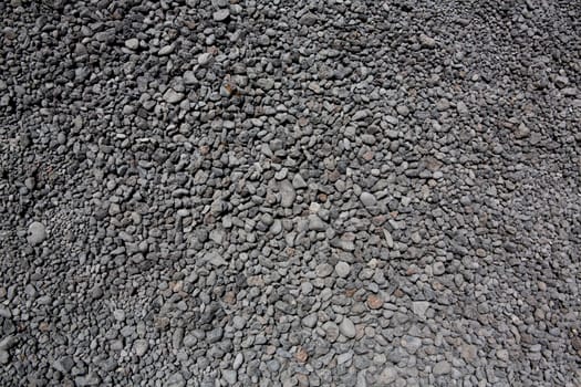 black gray volcanic lava rolling stones texture in Lanzarote