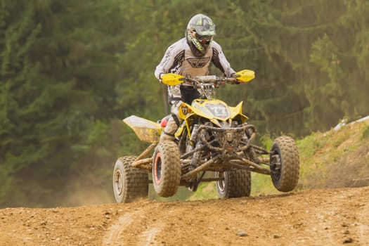 MOHELNICE,  CZECH REPUBLIC - SEPTEMBER 08: Racer rides a yellow quad motorbike in the "International Championship of the Czech Republic 2012"" on September 08, 2012 in MOHELNICE, Czech Republic."