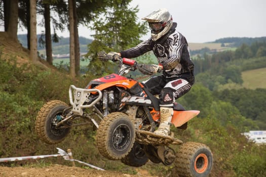 MOHELNICE,  CZECH REPUBLIC - SEPTEMBER 08: Unidentified racer jumps a quad motorbike in the "International Championship of the Czech Republic 2012"" on September 08, 2012 in MOHELNICE, Czech Republic."