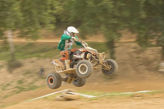 MOHELNICE,  CZECH REPUBLIC - SEPTEMBER 08: Panning shot of  racer jumps a quad motorbike in the "International Championship of the Czech Republic 2012"" on September 08, 2012 in MOHELNICE, Czech Republic."