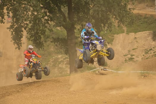 MOHELNICE,  CZECH REPUBLIC - SEPTEMBER 08: Unidentified two racers jump a quad motorbike in the "International Championship of the Czech Republic 2012"" on September 08, 2012 in MOHELNICE, Czech Republic."