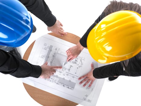 Two architects with hard hats and plan on meeting in office