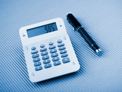 Calculator and pen on office table
