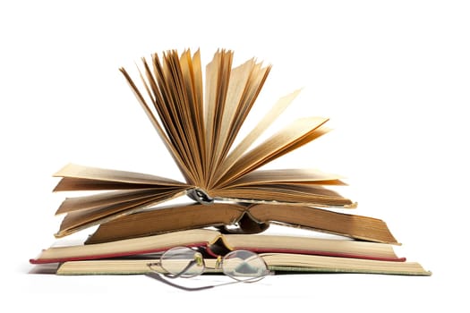Open Old Antique Books and Eyeglasses isolated on white