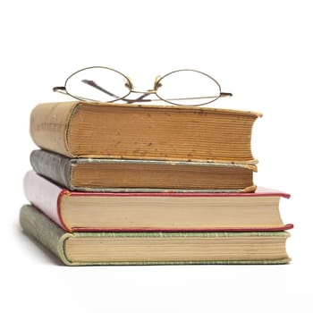 Group of Old Antique Books and eyeglasses isolated on white