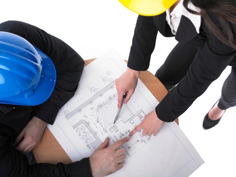Two architects with hard hats and plan on meeting in office