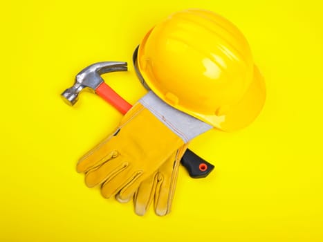 Worker equipment - HardHat Hammer And Gloves on yellow