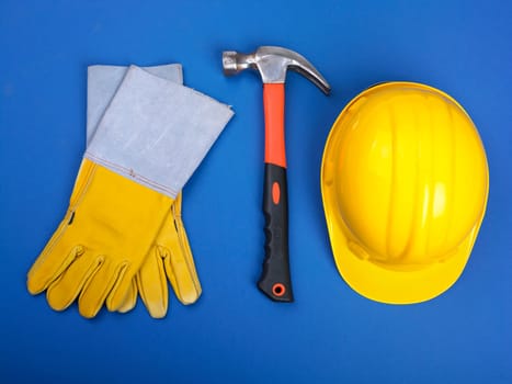 Worker equipment - HardHat Hammer And Leather Gloves on blue