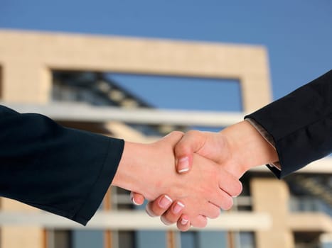 Handshake Handshaking and blured building in background