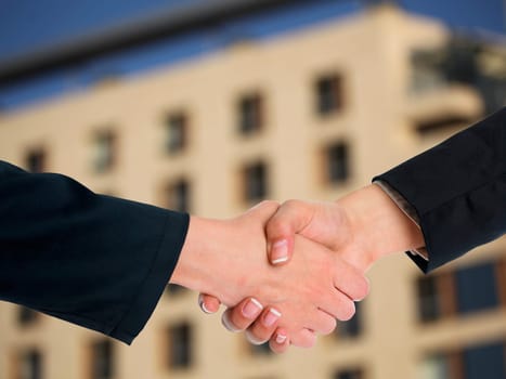 Handshake Handshaking and blured building in background