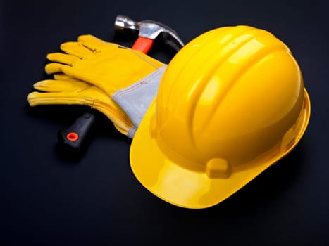 HardHat Hammer And Leather Gloves on black
