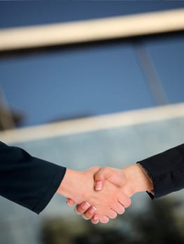 Handshake Handshaking and blured building in background