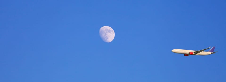 airplane, airliner flying past the moon, panoramic view