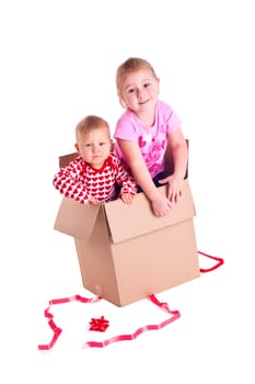 studio shot of two child in gift box