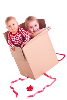 studio shot of two child in gift box