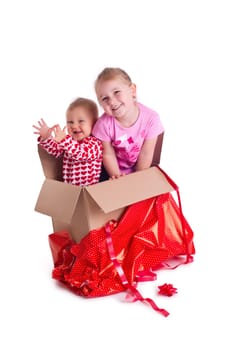 studio shot of two child in gift box