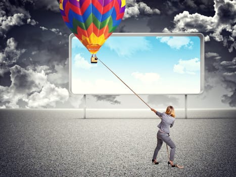 businesswoman pull hot air balloon