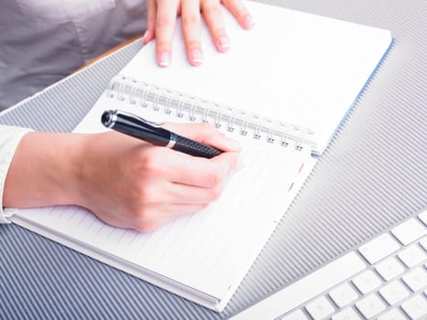 Office Assistant in white writing Schedule