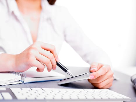 Office business woman calculating with calculator and pencil