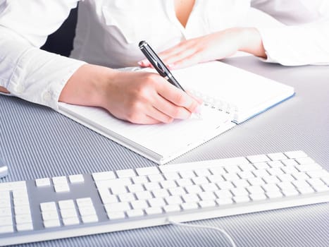 Office Assistant in white writing Schedule