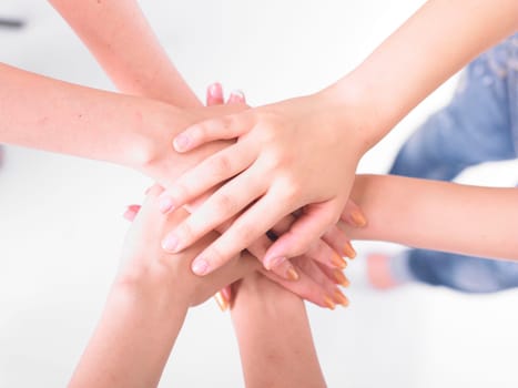 Business team join hands on white background