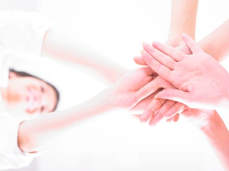Business team join hands on white background