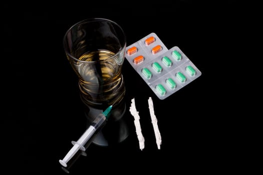 drugs and pills on black bacground with reflection