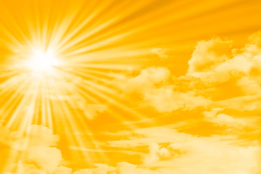 yellow sky with clouds, sun and sun rays