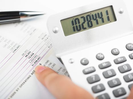 Market Analyze - pen and calculator on papers