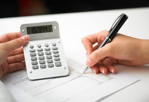 Market Analyze - pen and calculator on papers