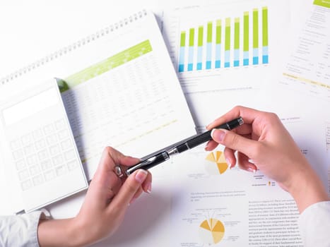 Analyzing Business Data - pen and numbers on paper