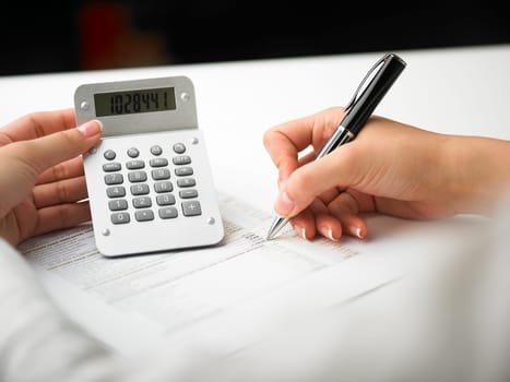 Market Analyze - pen and calculator on papers