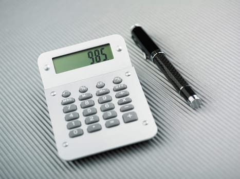 Calculator and pen on office table