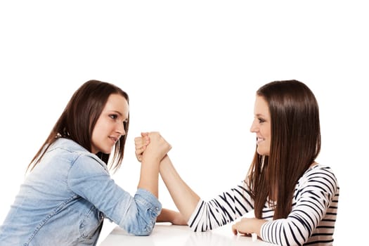 Girl wrestling arms against white background