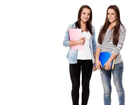 Two pretty schoolgirls with notepads against white background