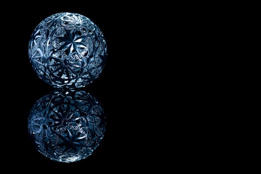 Metal Christmas Ornament on Black Mirror