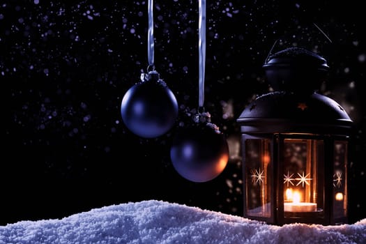 Lantern in the snow with baubles and blue light effects