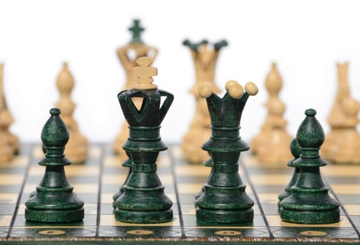 Chess board and chess pieces close up with withe background.