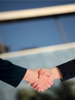 Handshake Handshaking and blured building in background