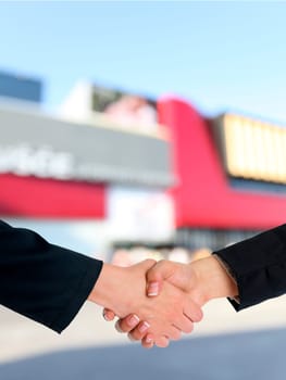 Handshake Handshaking and blured building in background