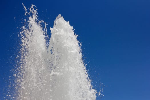 Fountain in front of blue sky horizontally