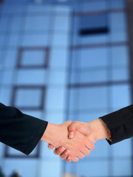 Handshake Handshaking and blured building in background