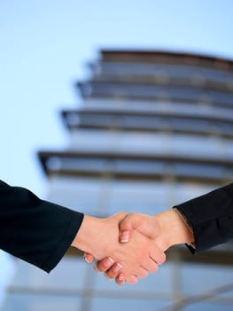Handshake Handshaking and blured building in background