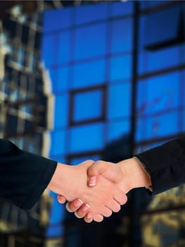Handshake Handshaking and blured building in background