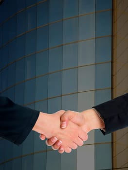 Handshake Handshaking and blured building in background