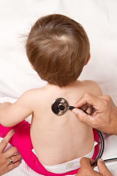 Children&#039 s doctor exams infant with stethoscope