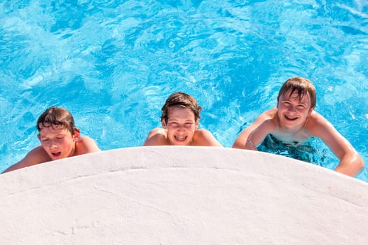 cute boys have fun in the pool
