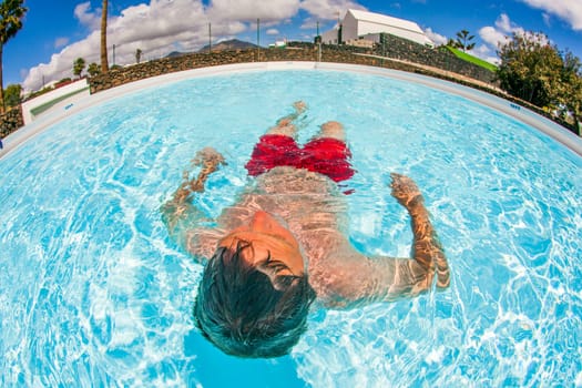 smart man enjoys swimming in the pool