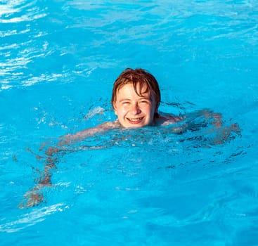 cute boy swimming in the pool