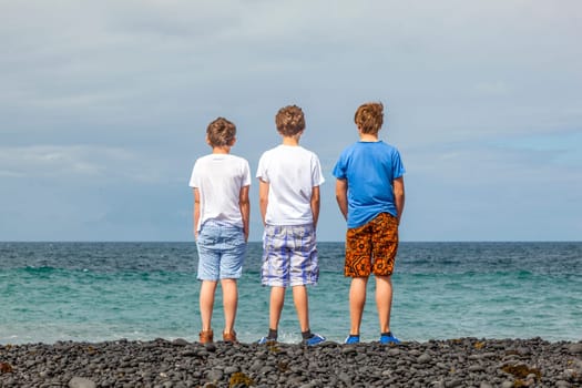 boys have fun at the black volcanic beach